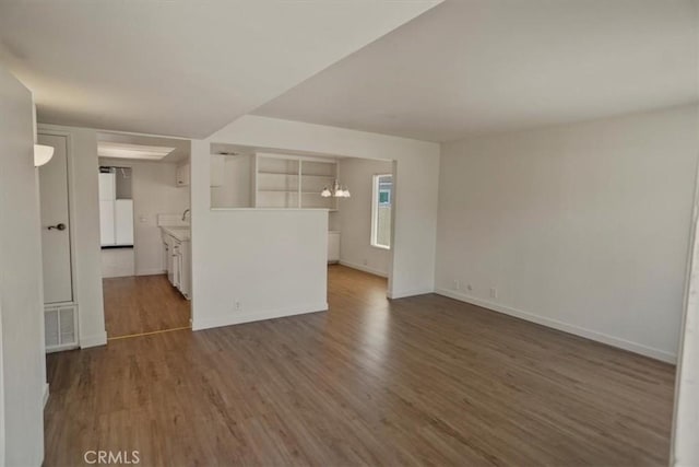 1138 N Valley St, Burbank, CA 91505 - unfurnished living room with dark wood-style floors and a chandelier