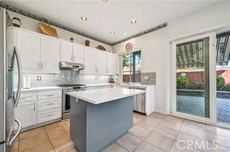 14213 Aliso Ct, Chino Hills, CA 91709 - kitchen with appliances with stainless steel finishes, under cabinet range hood, light tile patterned flooring, white cabinets, and recessed lighting