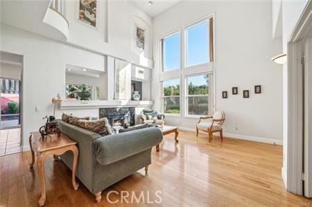 14213 Aliso Ct, Chino Hills, CA 91709 - living area with healthy amount of natural light, a towering ceiling, and light wood finished floors