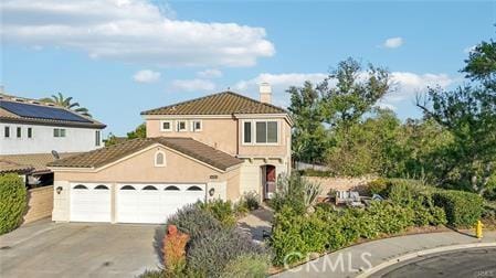 14213 Aliso Ct, Chino Hills, CA 91709 - view of front of home featuring driveway, a garage, a chimney, stucco siding, and a tiled roof