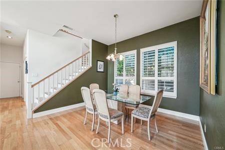14213 Aliso Ct, Chino Hills, CA 91709 - dining area featuring stairway, wood finished floors, and a chandelier
