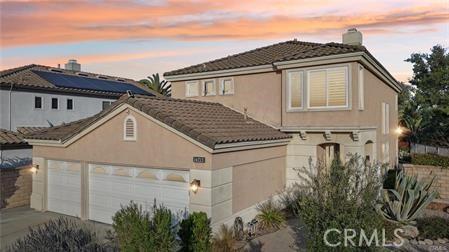 14213 Aliso Ct, Chino Hills, CA 91709 - view of front facade with concrete driveway, a tile roof, stucco siding, a chimney, and an attached garage