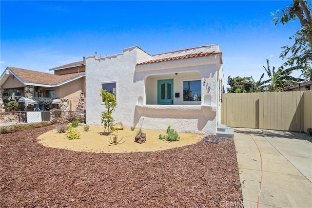 215 E 107th St, Los Angeles, CA 90003 - mediterranean / spanish house featuring stucco siding and a tile roof