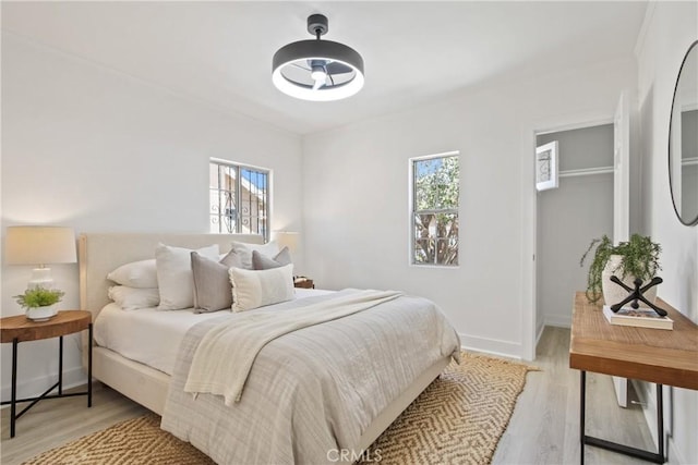 215 E 107th St, Los Angeles, CA 90003 - bedroom with light wood-type flooring and a spacious closet