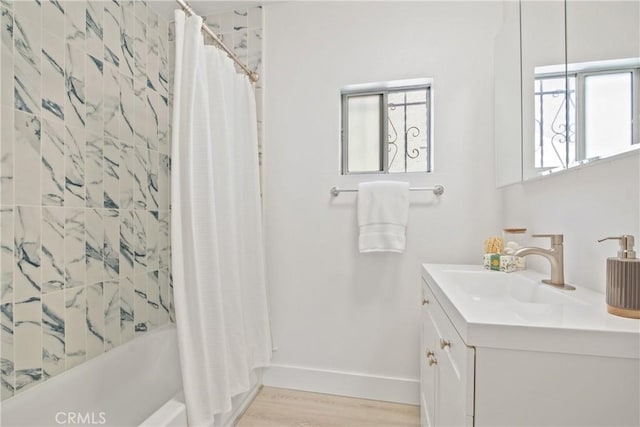 215 E 107th St, Los Angeles, CA 90003 - bathroom with vanity, healthy amount of natural light, wood finished floors, and shower / bathtub combination with curtain