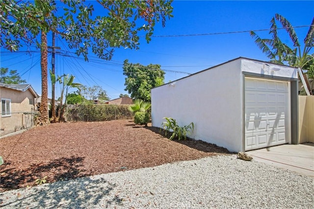 215 E 107th St, Los Angeles, CA 90003 - view of yard with a garage, concrete driveway, and an outdoor structure