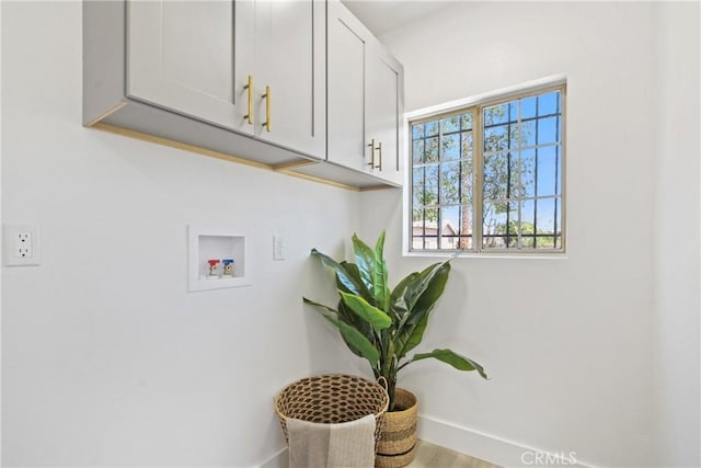 215 E 107th St, Los Angeles, CA 90003 - washroom featuring cabinet space, hookup for a washing machine, and wood finished floors