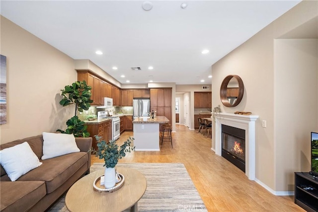 118 Vintage Unit 18, Irvine, CA 92620 - living room with light wood-style floors, recessed lighting, and a glass covered fireplace