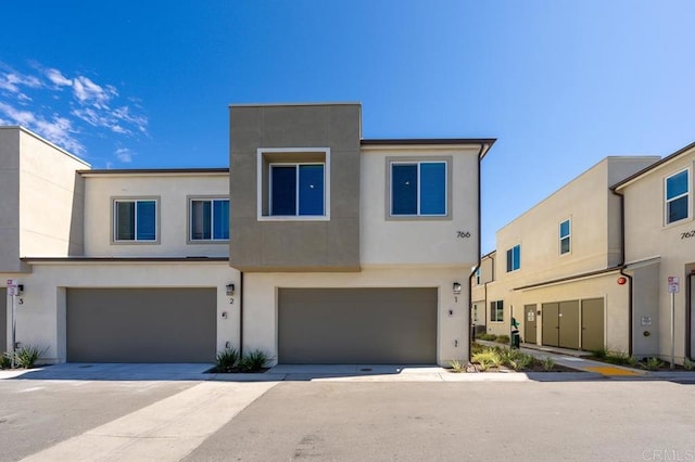 766 Makani St Unit 1, Chula Vista, CA 91911 - view of property featuring a garage and stucco siding