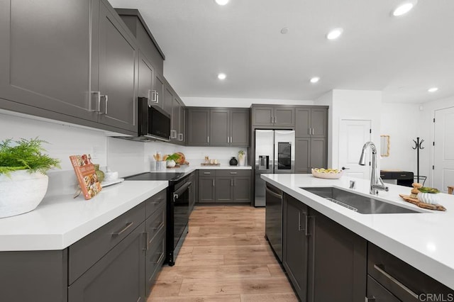766 Makani St Unit 1, Chula Vista, CA 91911 - kitchen with appliances with stainless steel finishes, recessed lighting, light wood-type flooring, and light countertops