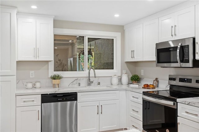 4025 Calle Sonora Este Unit 2C, Laguna Woods, CA 92637 - kitchen featuring appliances with stainless steel finishes, white cabinetry, recessed lighting, and light stone countertops
