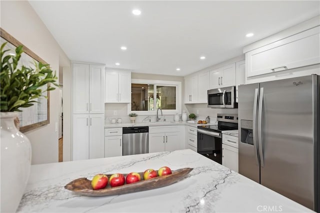 4025 Calle Sonora Este Unit 2C, Laguna Woods, CA 92637 - kitchen with stainless steel appliances, white cabinetry, light stone counters, and recessed lighting