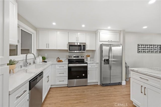 4025 Calle Sonora Este Unit 2C, Laguna Woods, CA 92637 - kitchen with stainless steel appliances, white cabinets, light stone counters, light wood finished floors, and recessed lighting