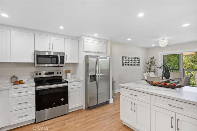 4025 Calle Sonora Este Unit 2C, Laguna Woods, CA 92637 - kitchen with stainless steel appliances, white cabinetry, recessed lighting, light wood-style flooring, and light stone counters