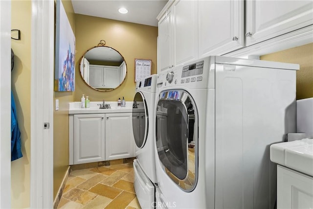 15 Pisano St, Ladera Ranch, CA 92694 - laundry room with washer and clothes dryer, stone tile flooring, cabinet space, and recessed lighting