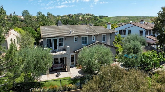 15 Pisano St, Ladera Ranch, CA 92694 - back of house with a chimney, stucco siding, an outdoor hangout area, a patio area, and a fenced backyard