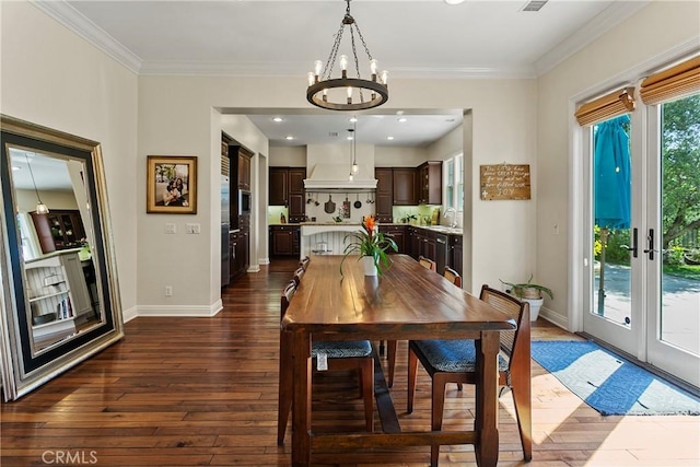 15 Pisano St, Ladera Ranch, CA 92694 - dining room featuring dark wood-style floors, a chandelier, and ornamental molding