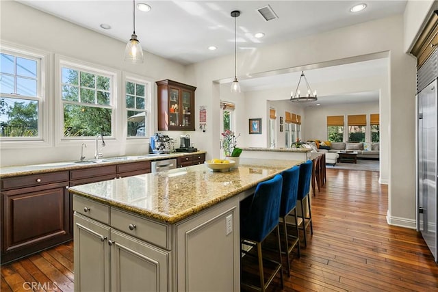 15 Pisano St, Ladera Ranch, CA 92694 - kitchen featuring a center island, dark wood finished floors, open floor plan, pendant lighting, and recessed lighting