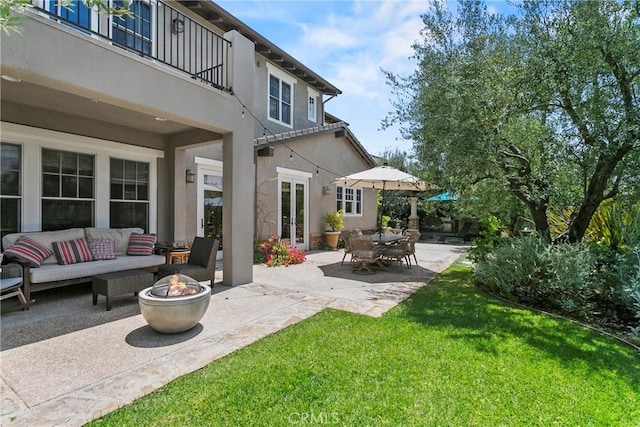 15 Pisano St, Ladera Ranch, CA 92694 - patio / terrace featuring a patio area, a lawn, and an outdoor living space with a fire pit
