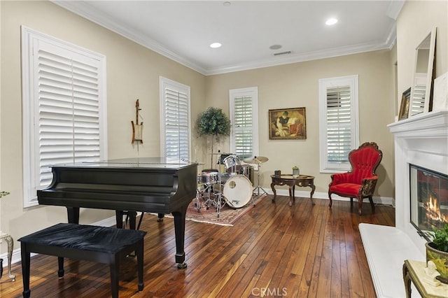 15 Pisano St, Ladera Ranch, CA 92694 - sitting room with hardwood / wood-style flooring, a glass covered fireplace, ornamental molding, and recessed lighting