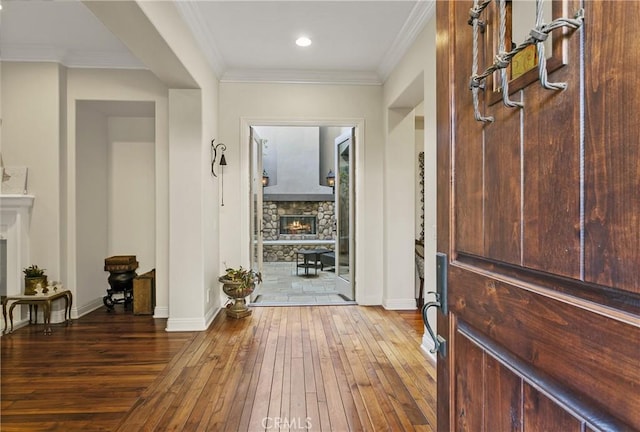 15 Pisano St, Ladera Ranch, CA 92694 - foyer entrance featuring a fireplace, wood-type flooring, and ornamental molding