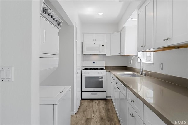 19859 Claremont Ln, Huntington Beach, CA 92646 - kitchen featuring white appliances, washer / dryer, white cabinets, wood finished floors, and recessed lighting