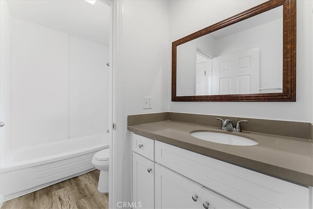 19859 Claremont Ln, Huntington Beach, CA 92646 - bathroom featuring vanity, wood finished floors, and shower / washtub combination