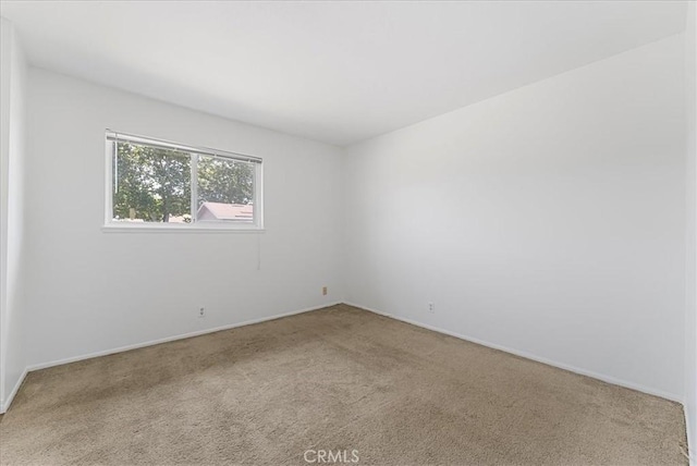 19859 Claremont Ln, Huntington Beach, CA 92646 - carpeted empty room featuring baseboards