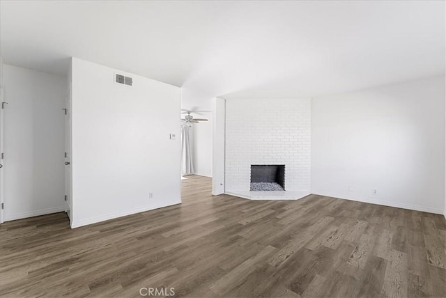 19859 Claremont Ln, Huntington Beach, CA 92646 - unfurnished living room with wood finished floors, a brick fireplace, and a ceiling fan