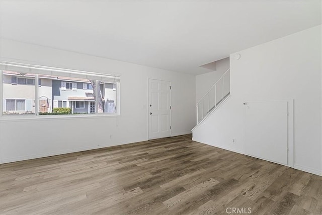 19859 Claremont Ln, Huntington Beach, CA 92646 - unfurnished living room with wood finished floors and stairway