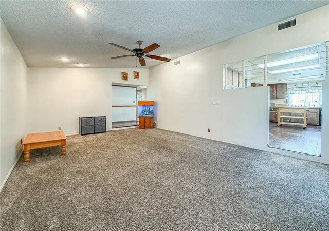2191 Hilldale Ave, Simi Valley, CA 93063 - unfurnished living room featuring carpet floors, a textured ceiling, and ceiling fan