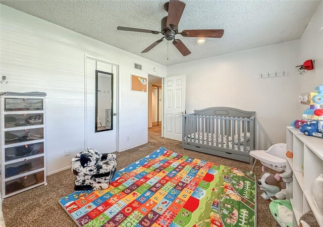 2191 Hilldale Ave, Simi Valley, CA 93063 - bedroom with a textured ceiling, carpet floors, a ceiling fan, and a crib