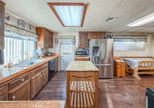 2191 Hilldale Ave, Simi Valley, CA 93063 - kitchen featuring appliances with stainless steel finishes, dark wood-type flooring, light countertops, and brown cabinets