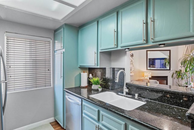 4658 Ohio St, San Diego, CA 92116 - kitchen with stainless steel dishwasher, dark stone counters, and wood finished floors