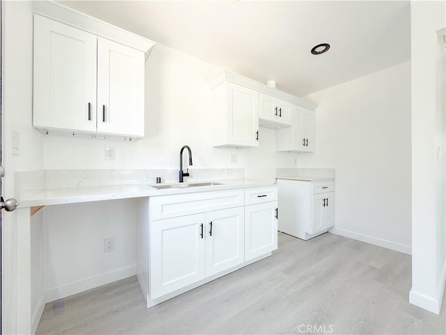 842 W Palmer St, Compton, CA 90220 - kitchen featuring light wood-style flooring and white cabinets