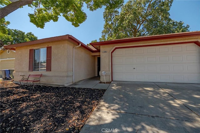 1584 Portola Way, Merced, CA 95348 - ranch-style home featuring concrete driveway, stucco siding, and a garage