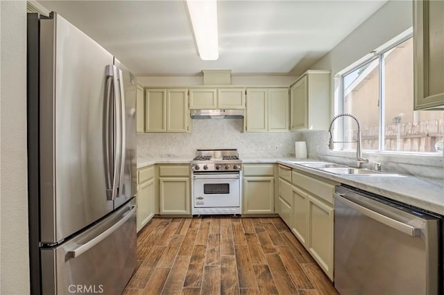 1584 Portola Way, Merced, CA 95348 - kitchen with appliances with stainless steel finishes, under cabinet range hood, dark wood-style flooring, and cream cabinets