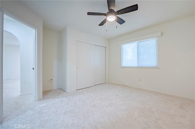 1584 Portola Way, Merced, CA 95348 - unfurnished bedroom featuring carpet flooring, arched walkways, a closet, and ceiling fan