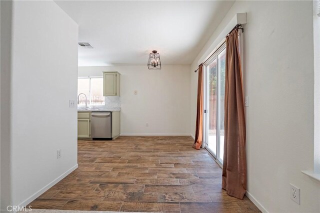 1584 Portola Way, Merced, CA 95348 - corridor featuring a chandelier and wood finished floors