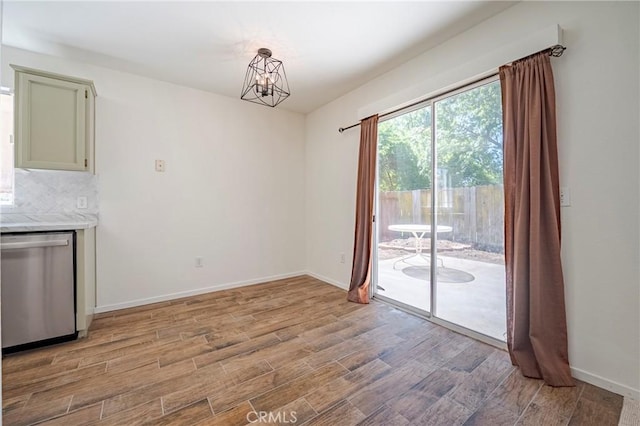 1584 Portola Way, Merced, CA 95348 - unfurnished dining area featuring light wood-style floors and a chandelier