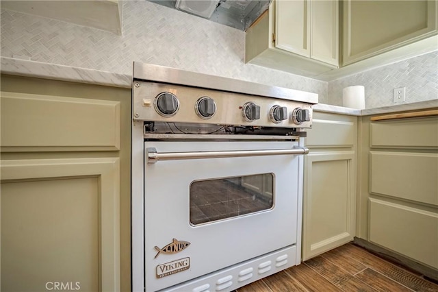 1584 Portola Way, Merced, CA 95348 - kitchen view of range, dark wood finished floors, tasteful backsplash, cream cabinets, and light countertops
