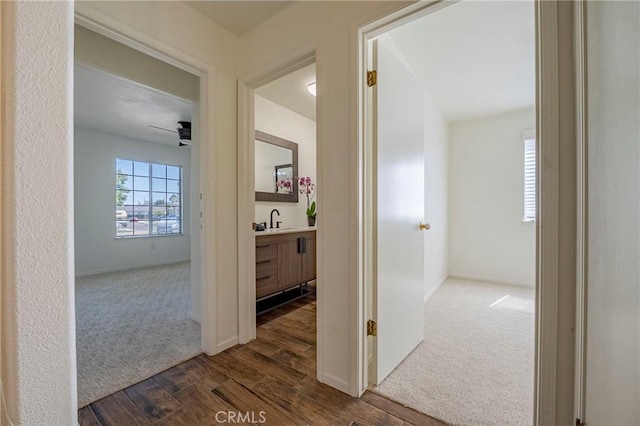 1584 Portola Way, Merced, CA 95348 - corridor with dark wood-type flooring and dark carpet