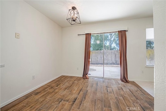 1584 Portola Way, Merced, CA 95348 - spare room with wood finished floors and a chandelier