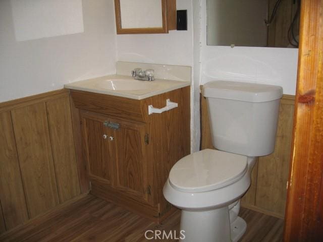2756 Circle Dr, Running Springs, CA 92382 - half bathroom with vanity, wood finished floors, and wainscoting