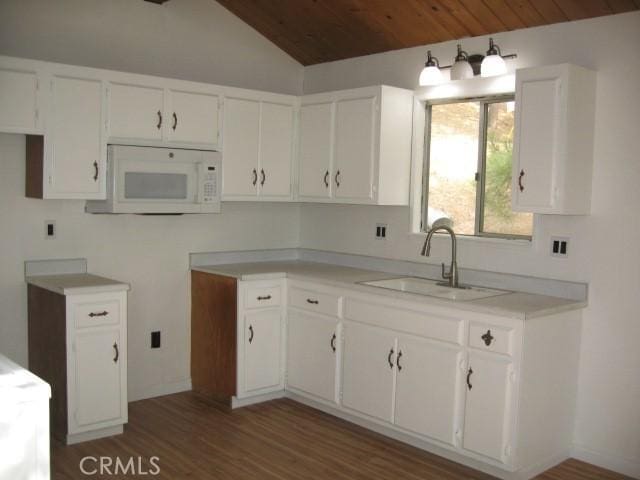 2756 Circle Dr, Running Springs, CA 92382 - kitchen with white microwave, wood ceiling, vaulted ceiling, wood finished floors, and white cabinets