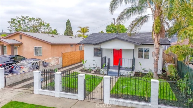 343 E 98th St, Los Angeles, CA 90003 - bungalow featuring stucco siding, a fenced front yard, a shingled roof, and a gate