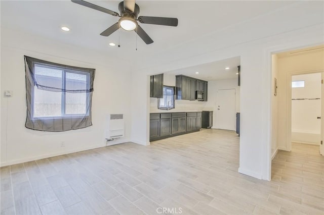 343 E 98th St, Los Angeles, CA 90003 - unfurnished living room featuring a ceiling fan, light wood finished floors, heating unit, and recessed lighting