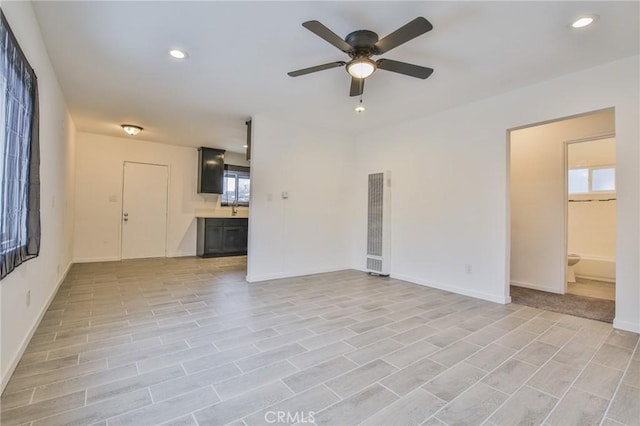 343 E 98th St, Los Angeles, CA 90003 - unfurnished living room featuring a heating unit, a ceiling fan, and recessed lighting