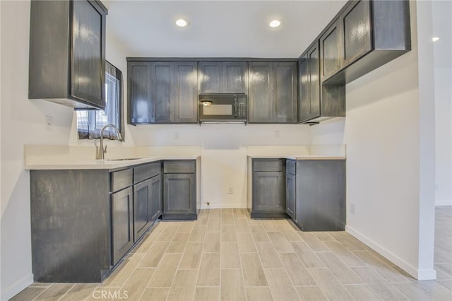 343 E 98th St, Los Angeles, CA 90003 - kitchen with black microwave, recessed lighting, light wood-style flooring, and light countertops