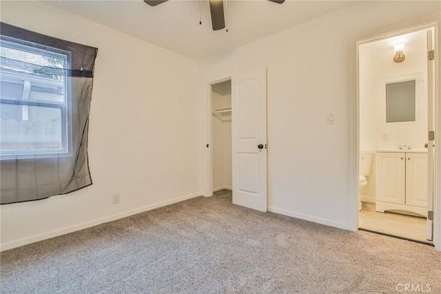 343 E 98th St, Los Angeles, CA 90003 - unfurnished bedroom featuring carpet floors, connected bathroom, and a ceiling fan